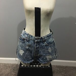 Vintage distressed Levi’s denim shorts.